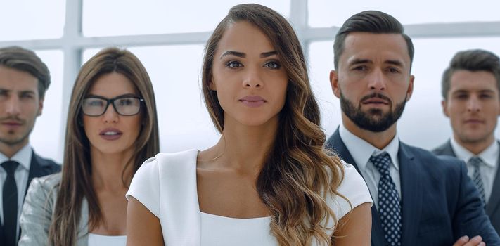 young business woman in front of the business team. the concept of teamwork