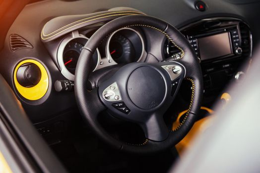 Modern car interior dashboard and steering wheel.