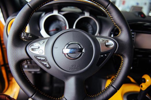 Modern car interior dashboard and steering wheel.