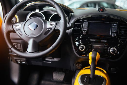 Modern car interior dashboard and steering wheel.