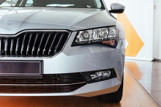 The headlights and the hood of a black sports car.