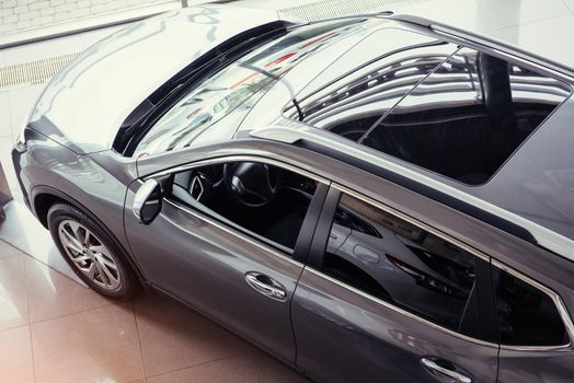 of the car in the spacious showroom with large windows.