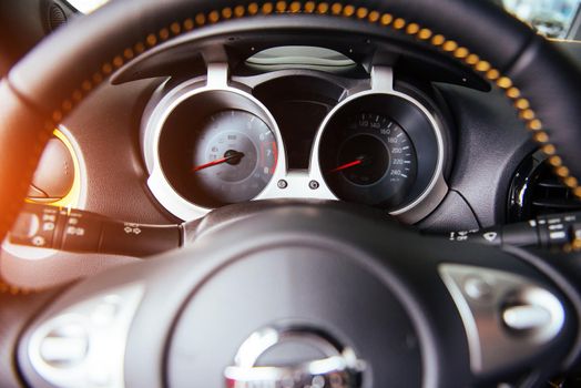 Modern car interior dashboard and steering wheel.