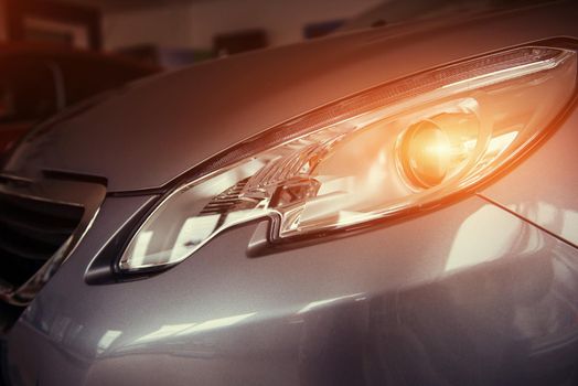 The headlights and the hood of a black sports car.