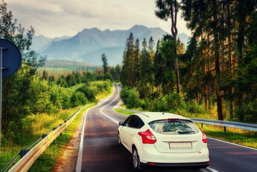 The car on asphalt road in the mountains. Carpathian. Ukraine, Europe.