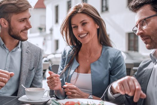 business colleagues sitting at a table in a cafe.the concept of teamwork