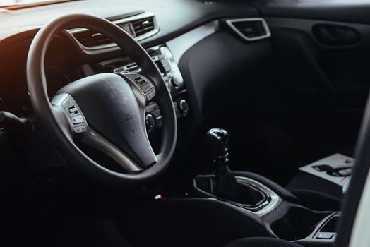 Modern car interior dashboard and steering wheel.