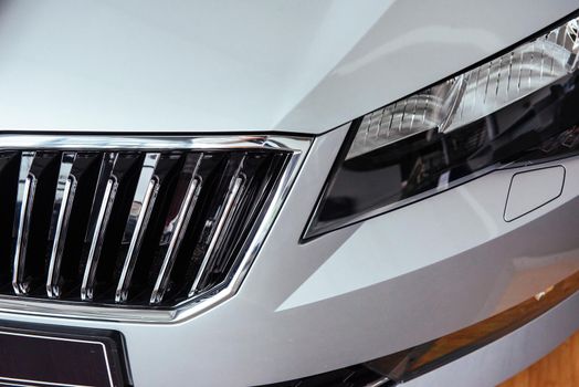 The headlights and the hood of a black sports car.