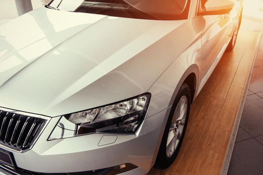 The headlights and the hood of a black sports car.