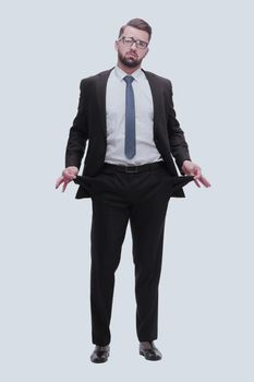 in full growth. frustrated businessman showing his empty pockets. isolated on white background
