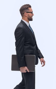 in full growth. successful businessman with laptop stepping forward. isolated on white background