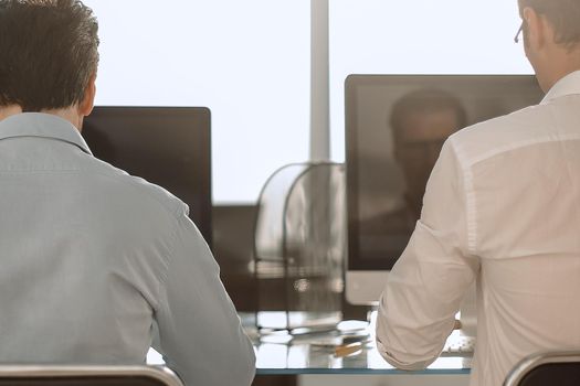 rear view.two business people working at the Desk.business concept