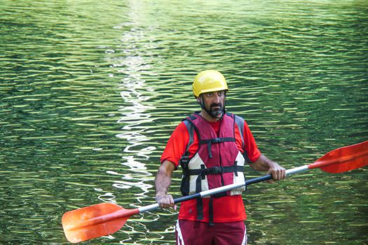 man warming up with the paddle before kayaking down the river