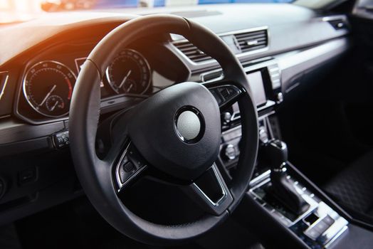 Modern car interior dashboard and steering wheel.