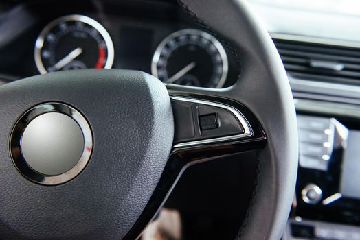 Modern car interior dashboard and steering wheel.