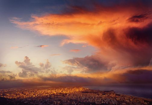 Sunset over the city from a height. The dramatic and picturesque scene. Location Trapani, Erice, Sicily, Italy, Europe. Mediterranean and Tyrrhenian Sea.