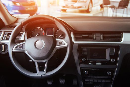 Modern car interior dashboard and steering wheel.