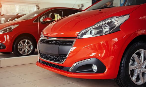 Headlights and hood of sport red car.