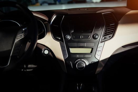 Modern car interior dashboard and steering wheel.