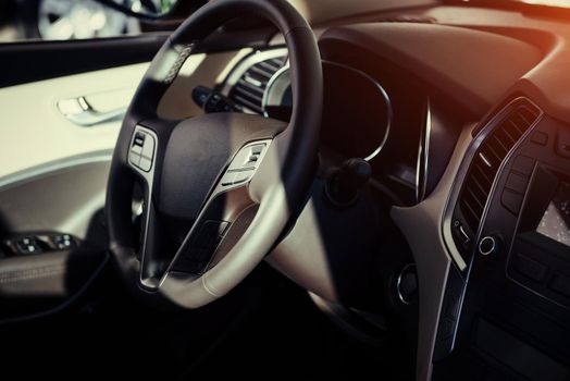 Modern car interior dashboard and steering wheel.
