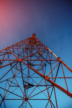 High metal tower on blue sky. Large scale