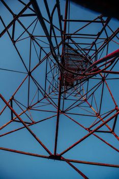 High metal tower on blue sky. Large scale