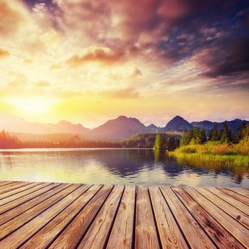 The sunrise over a lake in the park High Tatras. Shtrbske Pleso, Slovakia, Europe.