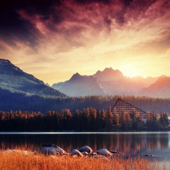 The sunrise over a lake in the park High Tatras. Shtrbske Pleso, Slovakia, Europe.