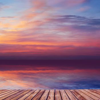 Beautiful sunset over sea with reflection in water, majestic clouds in the sky