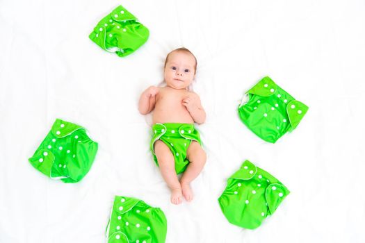 Reusable diaper on the baby copy space . An article about reusable diapers. Saving on diapers. Concern for the environment. Eco-products. Breathable diapers with buttons. High quality photo