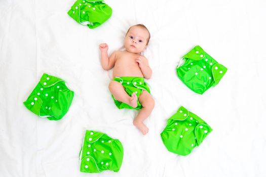 Reusable diaper on the baby copy space . An article about reusable diapers. Saving on diapers. Concern for the environment. Eco-products. Breathable diapers with buttons. High quality photo