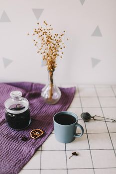 Breakfast with cup of tea and cookies on the table.