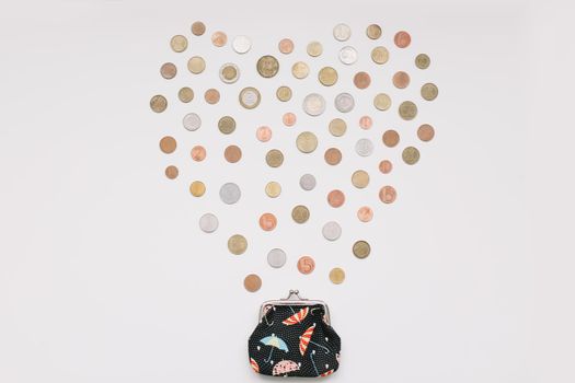 Open purse with different coins isolated on white background top view. Financial crisis, poverty, lack of money