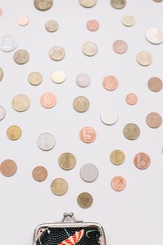 Open purse with different coins isolated on white background top view. Financial crisis, poverty, lack of money