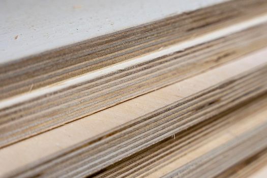 a stack of thick sheets of wooden plywood in a hardware store. wooden sheet. Sale of wooden building materials, repair