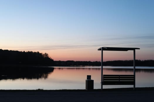 sunset at coast of the lake. Nature landscape. Reflection, blue sky and yellow sunlight. landscape during sunset.