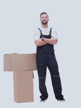 in full growth. smiling man standing near cardboard boxes. photo with copy space