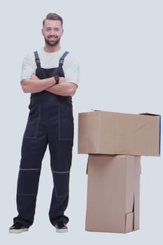 in full growth. smiling man standing near cardboard boxes. photo with copy space
