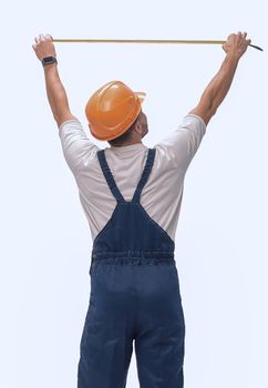 in full growth. man Builder with construction tape measure. isolated on white background