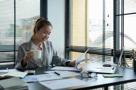 Business asian woman Discussing planning analyzing financial document data charts and graphs in office.