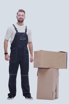 in full growth. smiling man standing near cardboard boxes. photo with copy space