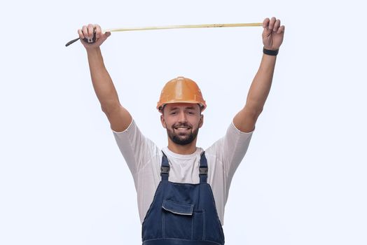 in full growth. man Builder with construction tape measure. isolated on white background