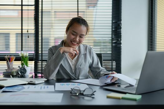 Business asian woman Discussing planning analyzing financial document data charts and graphs in office.