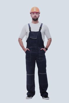 in full growth. confident man in overalls . isolated on white background