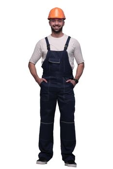 in full growth. confident man in overalls . isolated on white background