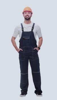 in full growth. confident man in overalls . isolated on white background