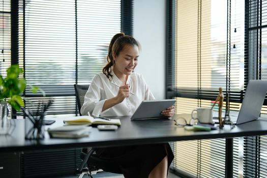 Young asian business woman working on laptop in office.