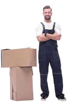 in full growth. smiling man standing near cardboard boxes. photo with copy space