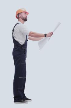 in full growth. competent foreman Builder looking at drawings. isolated on white background