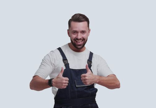 in full growth. friendly man in overalls showing thumbs up. isolated on white background